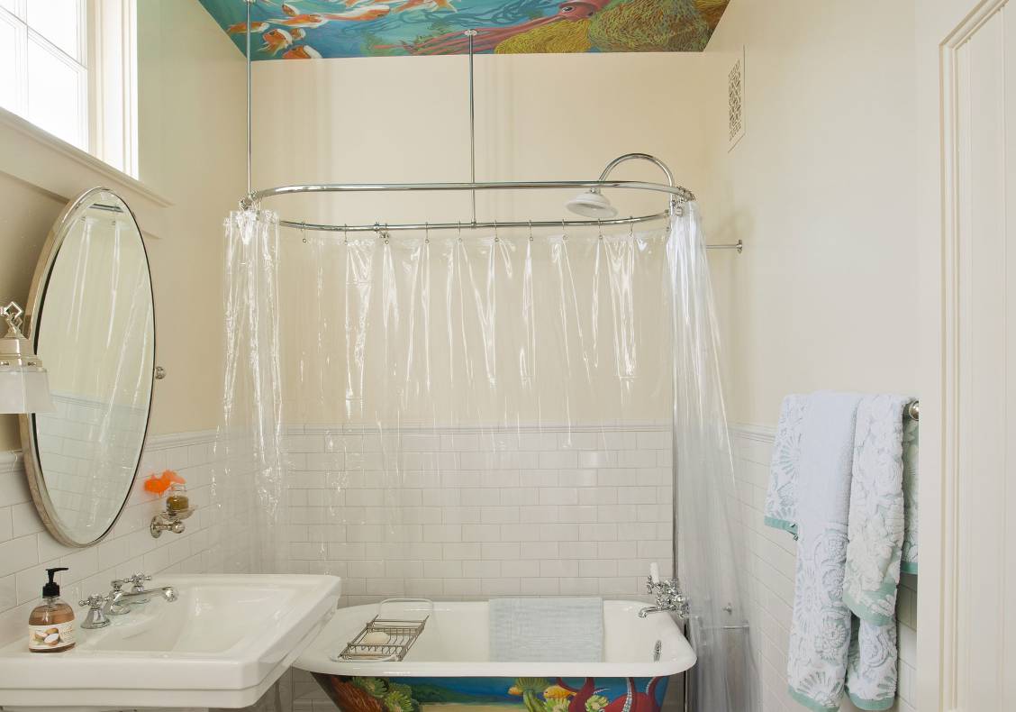 Ocean life motif painted ceiling and claw-footed tub.